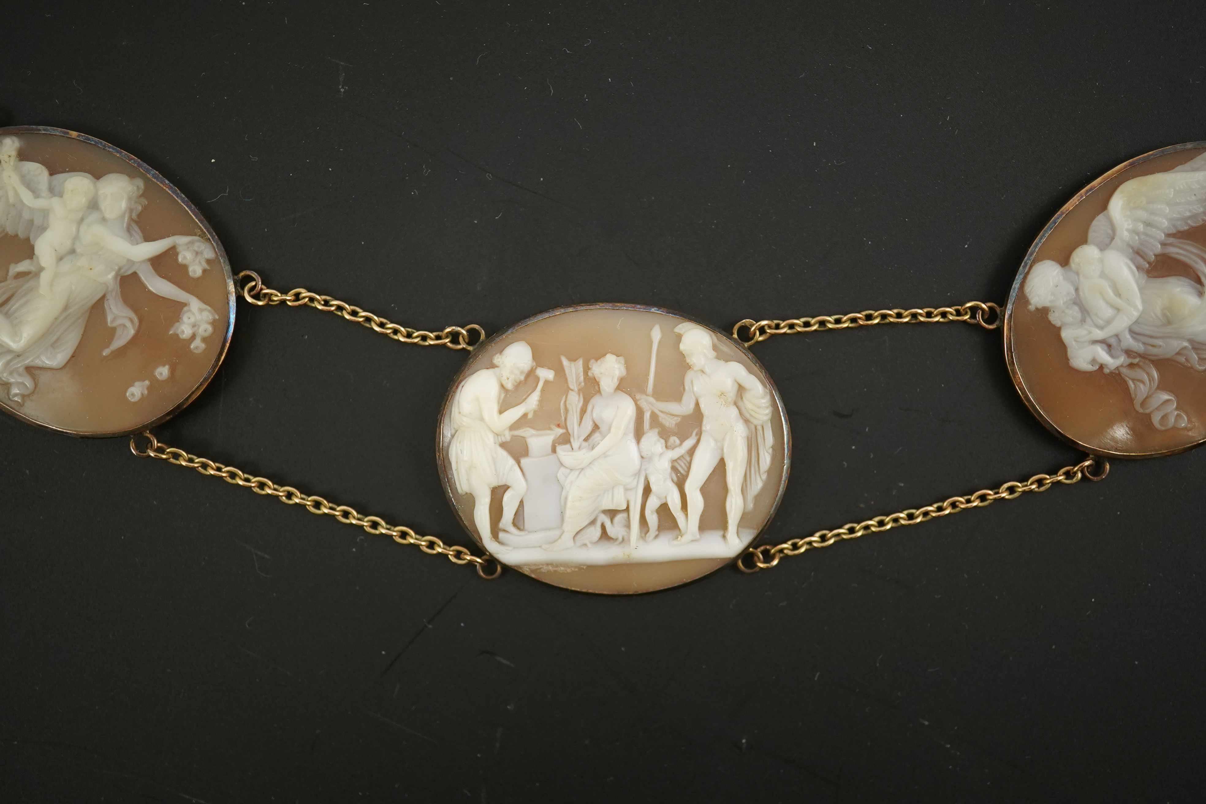 An early 19th century Italian Grand Tour gold double chain link and ten graduated oval cameo shell set necklace